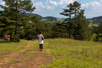 Tourist girl hiker hiking in the mountains