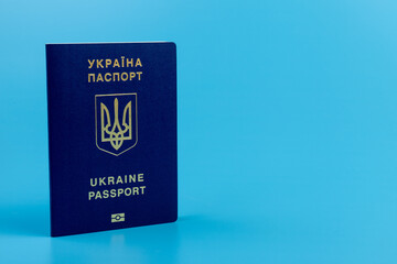 Ukrainian passport with a golden trident symbol on blue background. Biometric Ukraine passport id empty place for photo or text.