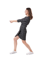 Businesswoman pulling an imaginary weight