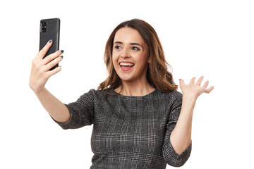 Fototapeta premium Happy businesswoman in a live video conference on her smartphone