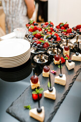 Fruit snacks on the table, glasses of champagne. Wedding buffet. Strawberries and blueberries 