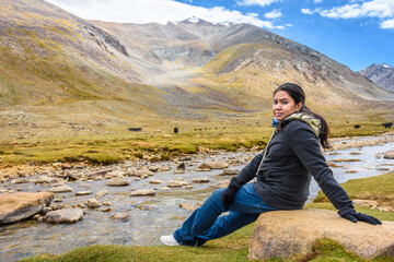 Young Indian woman solo traveller enjoying the beautiful landscape of Ladakh