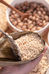 Making zongzi food - preparing and wrapping Chinese rice dumpling.