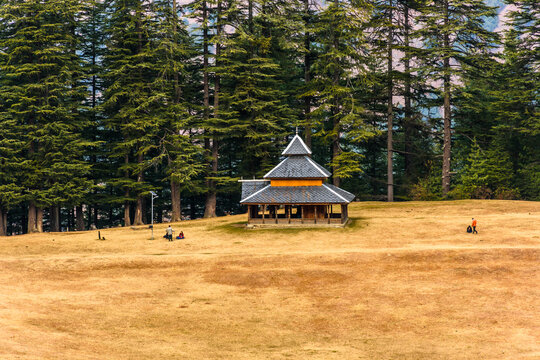 Shangchul mahadev temple in the meadow of Shahgarh, surrounded by Deodar Tree and Himalayas mountains in Sainj Valley, Great Himalayan National Park, Himachal Pradesh, India