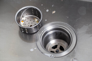 Filter mesh in the sink to clean the drain hole in the sink from particles of food, close-up