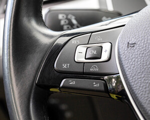 A modern feature in the car is the adaptive cruise control button on the steering wheel. Change of...