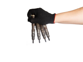 Diesel nozzles in the hand of a car mechanic on a white background, isolate. Setting up and adjusting the car's fuel system, close-up