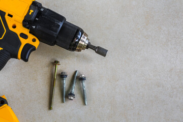 Cordless Hammer Drill/Driver with screw on Cement board background