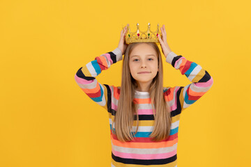 selfish teen child in queen crown on yellow background