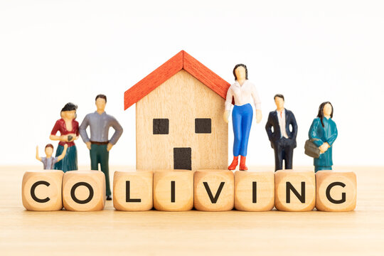 Coliving concept. Sharing economy Communal co-living. Wooden blocks with text, house and human figurines