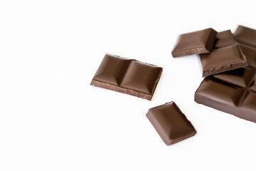 Close up view of blurred chocolate pieces isolated on white.
