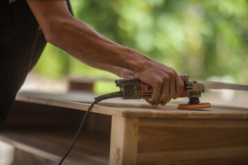 man grinding wood