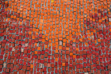 Orange color mosaic wall texture.