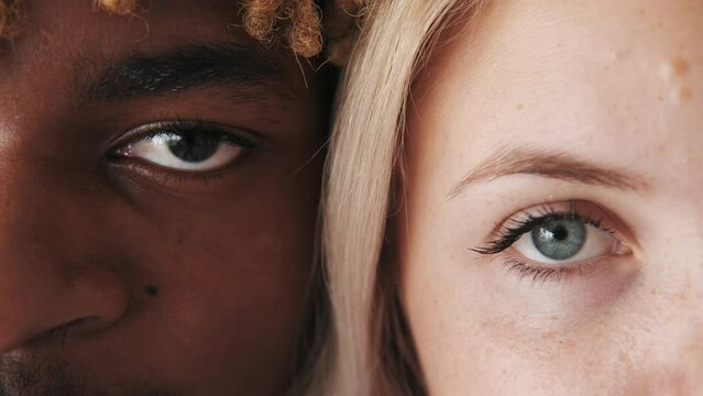 Diverse couple. Interracial relationship. International love. Closeup of confident happy man blonde woman eyes half face romantic portrait.