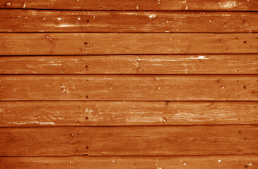 Wooden log house wall texture in orange tone.