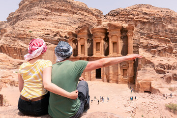 A young couple is watching the monastery of petra - Jordan - travel