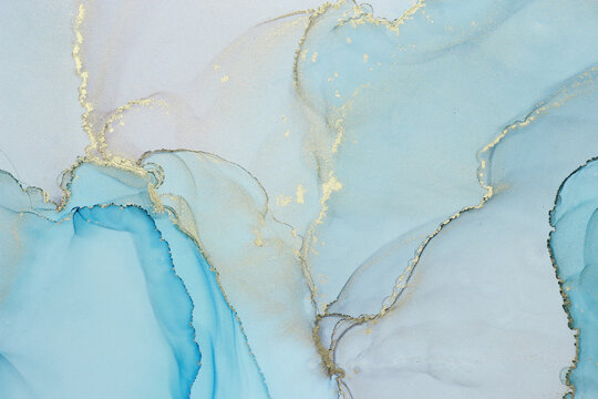 Abstract alcohol ink background in blue azure tones with golden splashes © Anntuan