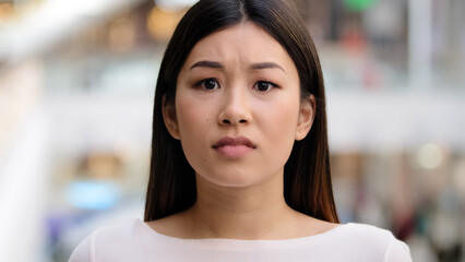 Close up female emotional face asiang girl shocked stressful woman model frightened lady scared horror disgust shock afraid unpleasant bad news unexpected surprise bankruptcy crisis war lose reaction - obrazy, fototapety, plakaty