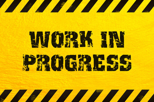 Work in progress warning sign on yellow wall background