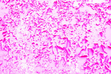 Old pink paint peeling from wall texture background. Cracked paint on metallic background. Grunge background