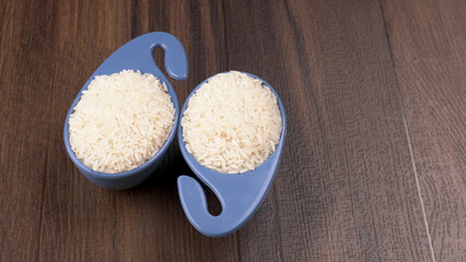 Uncooked dry rice in wooden bowl, Healthy food. Copy space.