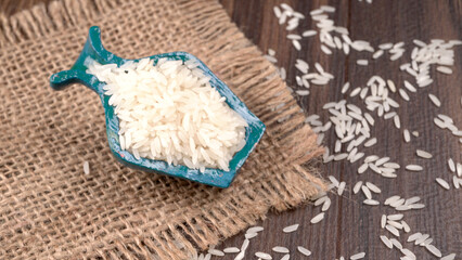 Uncooked dry rice in wooden bowl, Healthy food. Copy space.