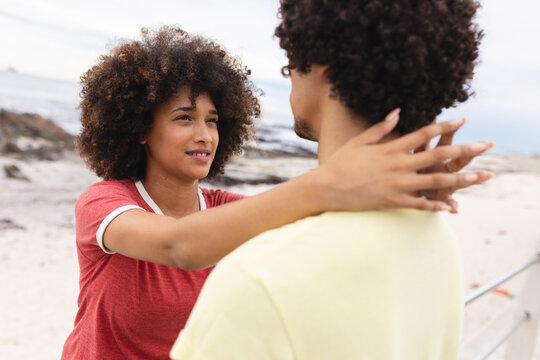 Loving young african american woman looking at afro boyfriend while spending leisure time together