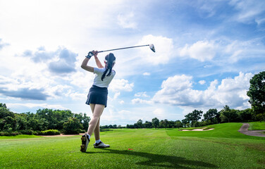 Professional woman golfer teeing  to hole  in player tournament competition at golf course for winner with green golf background. - obrazy, fototapety, plakaty