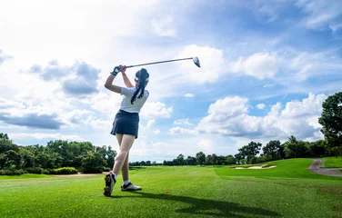 Foto auf Acrylglas Professional woman golfer teeing  to hole  in player tournament competition at golf course for winner with green golf background. © APstudio