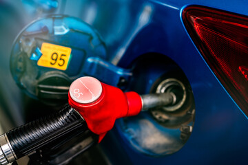 Car fueling at gas station. Refuel fill up with petrol gasoline. Petrol pump filling fuel nozzle in...