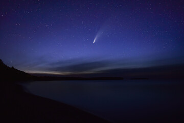 Beautiful shot of a starry blue night sky with a shooting star