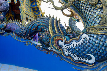 The blue serpent adorned the railing of the stairs. at Wat Rong Suea Ten Chiang Rai