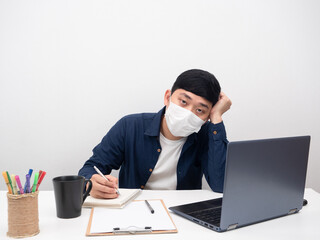 Man wearing mask fee sick sitting at workplace for working
