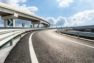 Poster Asphalt highway and bridge under blue sky. Road and sky background. © ABCDstock