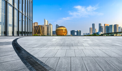 Empty square floor and city skyline with modern commercial buildings in Hangzhou, China.
