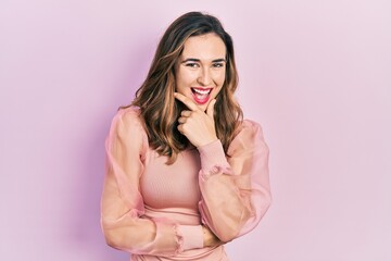 Young hispanic girl wearing casual clothes looking confident at the camera smiling with crossed arms and hand raised on chin. thinking positive.