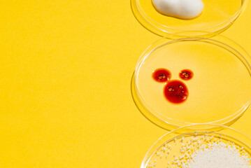 Cosmetic swatches. Appearance of the texture of the red mask, foam and granules in petri dish on a yellow background. Natural skincare products. Beauty concept for face and body care