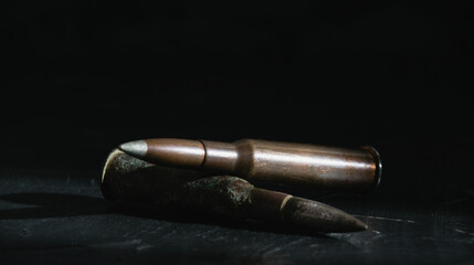 Ammunition on a dark background close-up, banner format. The concept of modern armaments and war in...