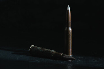 Cartridges on a dark background close-up, copy space. The concept of modern armaments and war in