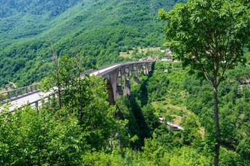 Concrete arch Durdevica Tara Bridge over Tara Canyon River in northern Montenegro.