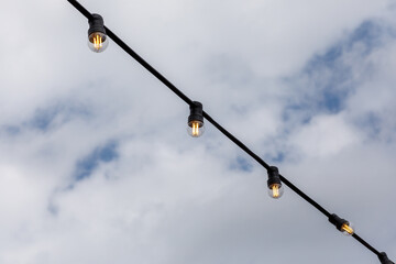 light bulbs garlands on a background of blue sky 