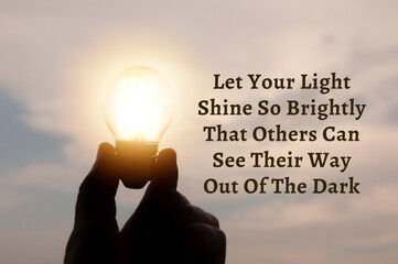 Motivational and Inspirational quote about inspire others. With hand holding light bulb in vintage color background. - Powered by Adobe