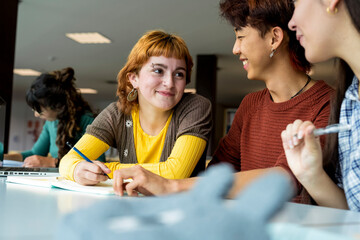 Group of college students studying together in a library
