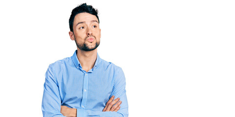 Hispanic man with beard with arms crossed gesture looking at the camera blowing a kiss being lovely...