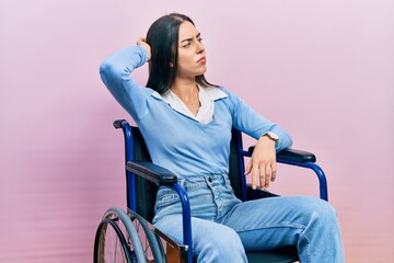 Beautiful woman with blue eyes sitting on wheelchair confuse and wondering about question....