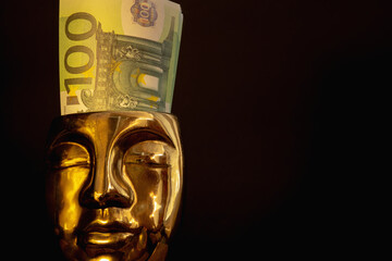 Fototapeta na wymiar Riches and gold concept. Golden face of a man with Euro money in head as a symbol care for wealth, money and business. Copy space