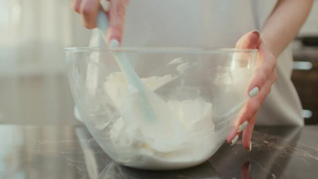 General shot of mixing cheese cream for birthday cake in a glass bowl