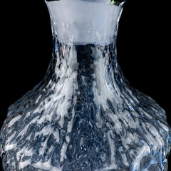 antique crystal decanter with engraving. vintage decanter for alcoholic beverages on a black...