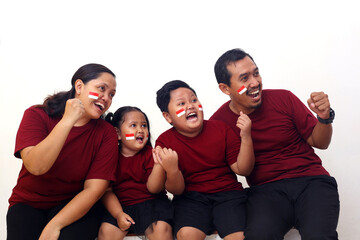 Happy asian family celebrate Indonesia Independence Day while looking beside them.Isolated on white