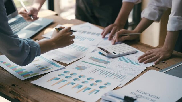Business Corporate team brainstorming, Planning Strategy having a discussion Analysis investment researching with chart at office his desk documents and saving concept.